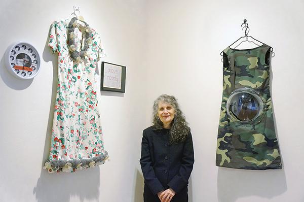 Mimi Smith, above, presaging the feminist artist movement, stands by her works, Slave Ready and Camouflage Maternity Dress. Photos by Victoria Rozario