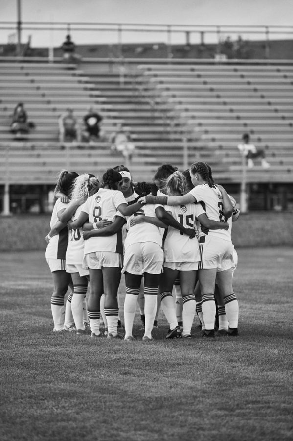 Womens Soccer team in a huddle during the 2019 season. 